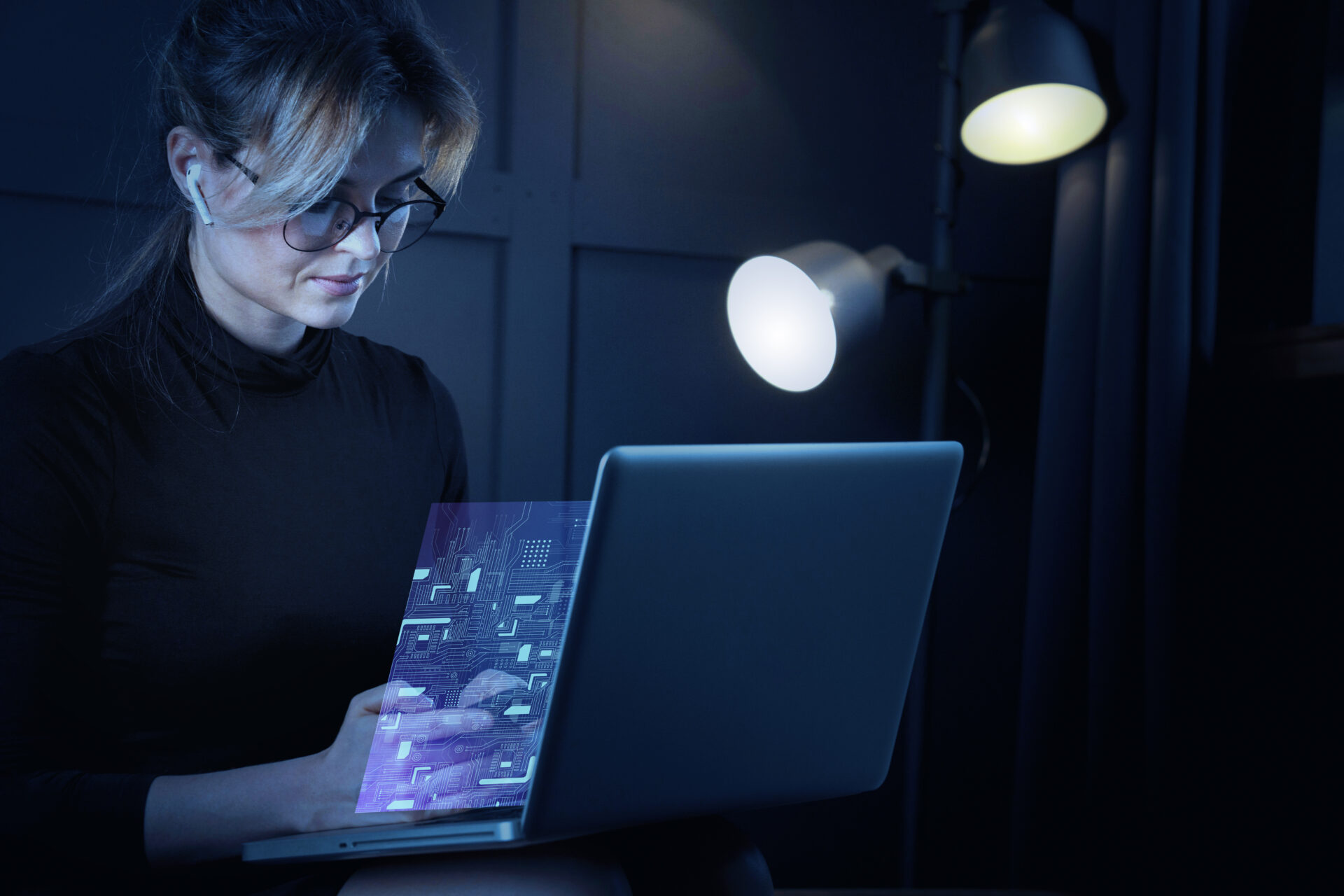 A woman on a laptop, working on Software-Driven Innovation.